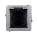 1-poolne kaitsega pistikupesa DECO koos maandusega. SCHUKO 2P+Z (läbipaistev kate), z/a, IP44, hõbedane metalliline värvus.