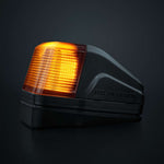 Strands IZE LED jumta gabarītlukturis ar brīdinājuma funkciju, balta/dzintara gaisma, tumša lēca, 10–32 V, IP69K, 903021