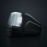 Strands IZE LED jumta gabarītlukturis ar brīdinājuma funkciju, balta/dzintara gaisma, tumša lēca, 10–32 V, IP69K, 903021